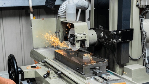 Surface grinding machine running at CAM Resources facility in Vietnam