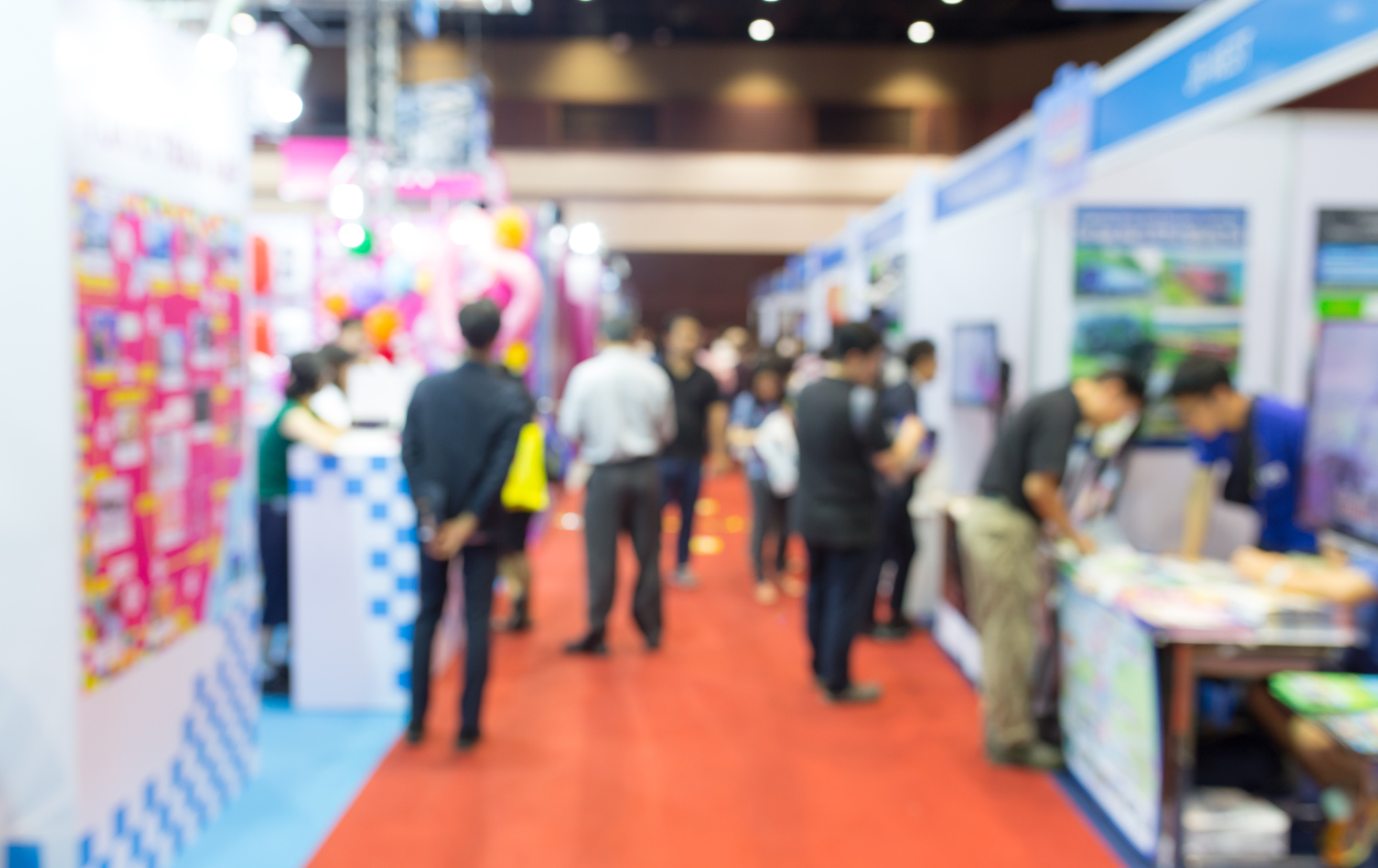 A business convention underway, with booths lined up